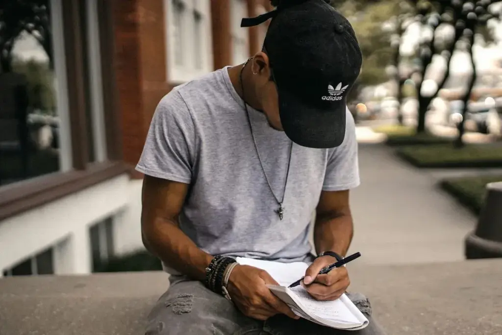 young man filling CV for job work application