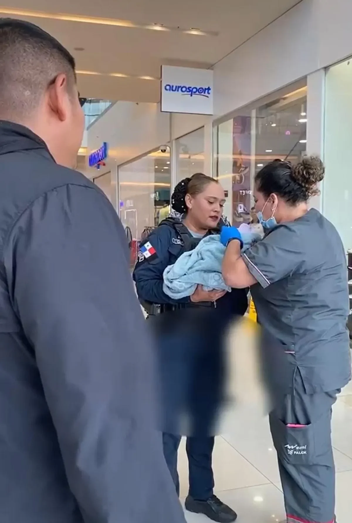 Police units recieve a newborn during a preventative patrol at a shopping center.